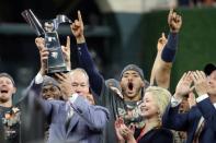 Oct 21, 2017; Houston, TX, USA; Houston Astros owner Jim Crane holds up the trophy after game seven of the 2017 ALCS playoff baseball series between the Houston Astros and the New York Yankees at Minute Maid Park. Thomas B. Shea-USA TODAY Sports