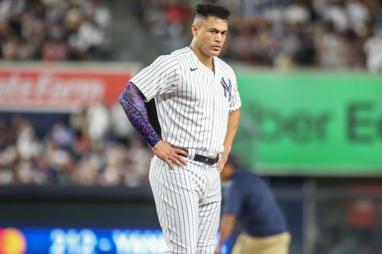 Aug 18, 2023; Bronx, New York, USA; New York Yankees right fielder Giancarlo Stanton (27) stays on the field after an inning ending double play in the sixth inning against the Boston Red Sox at Yankee Stadium.