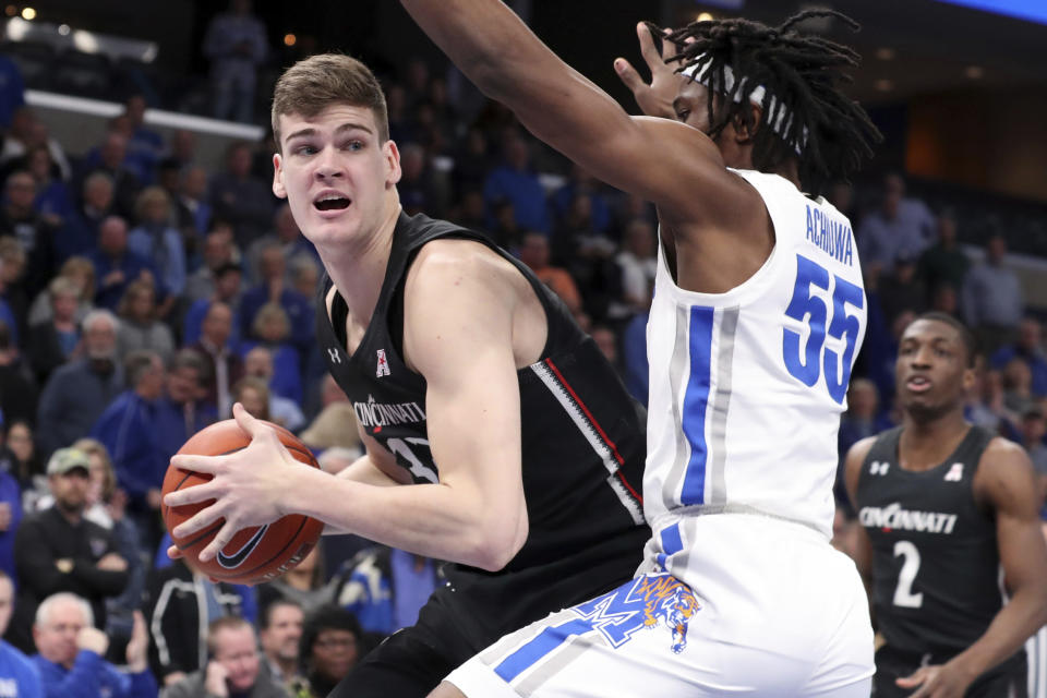 Memphis' forward Precious Achiuwa (55) defends Cincinnati's center Chris Vogt (33) in the first half of an NCAA college basketball game Thursday, Jan. 16, 2020, in Memphis, Tenn. (AP Photo/Karen Pulfer Focht)