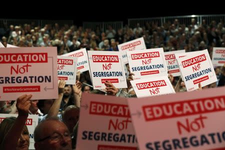 Delegates hold up placards as Britain's Shadow Secretary of State for Education Angela Rayner speaks during the third day of the Labour Party conference in Liverpool, Britain, September 27, 2016. REUTERS/Darren Staples