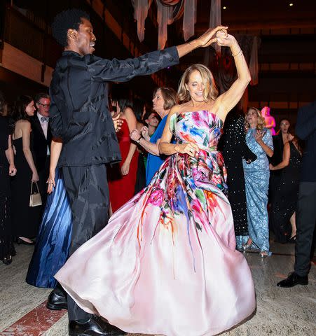 <p>Dimitrios Kambouris/Getty</p> Calvin Royal III and Katie Couric dance during the American Ballet Theatre Fall Gala