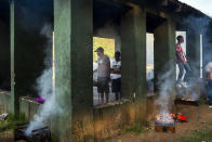 People celebrate South Africa's Heritage Day by cooking a barbecue at Zoo Lake park in Johannesburg Thursday Sept. 24, 2020. As the number of worldwide Covid-19 death is nearing the million mark, coronavirus related case numbers and deaths in South Africa hit the lowest in months. (AP Photo/Jerome Delay)