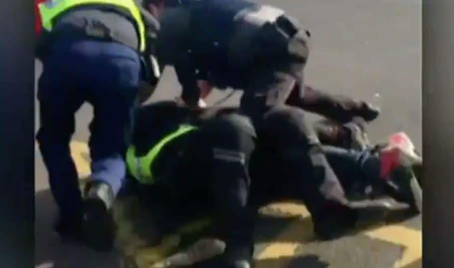 Several officers tackle the wanted man to the ground. Source: 7 News