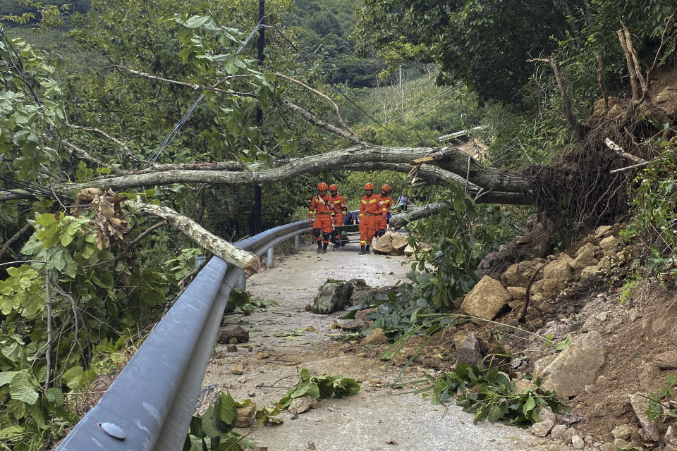 In this photo released by Xinhua News Agency, rescuers transfer an injured resident through a damaged road following an earthquake in Ziyachang Village of Luding County, southwest China's Sichuan Province Tuesday, Sept. 6, 2022. Authorities in southwestern China's Chengdu have maintained strict COVID-19 lockdown measures on the city of 21 million despite a major earthquake that killed dozens of people in outlying areas. (Wei Hong/Xinhua via AP)