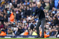Manchester City's head coach Pep Guardiola gives instructions to his players during the English Premier League soccer match between Manchester City and Arsenal at the Etihad stadium in Manchester, England, Sunday, March 31, 2024. (AP Photo/Dave Thompson)