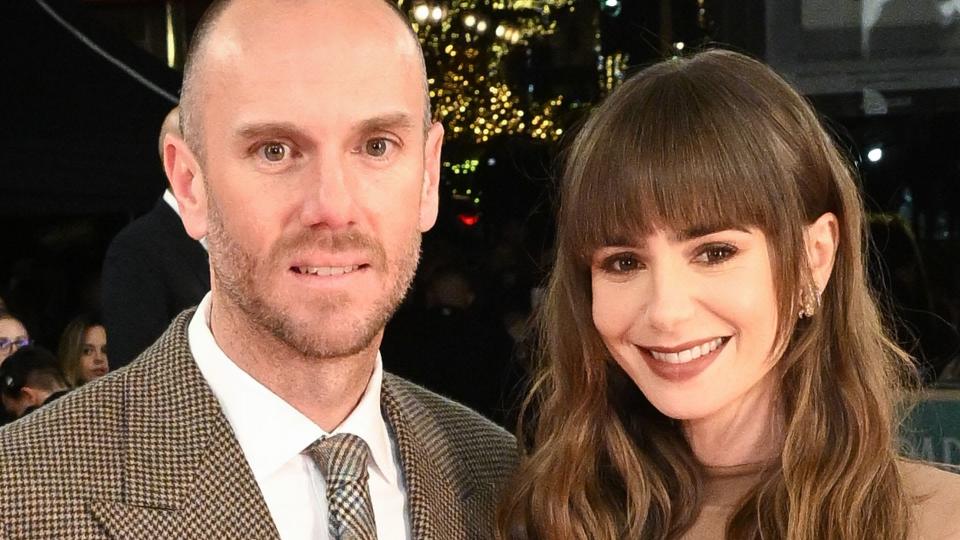 Charlie McDowell and Lily Collins in matching brown outfits attend Emily in Paris premiere