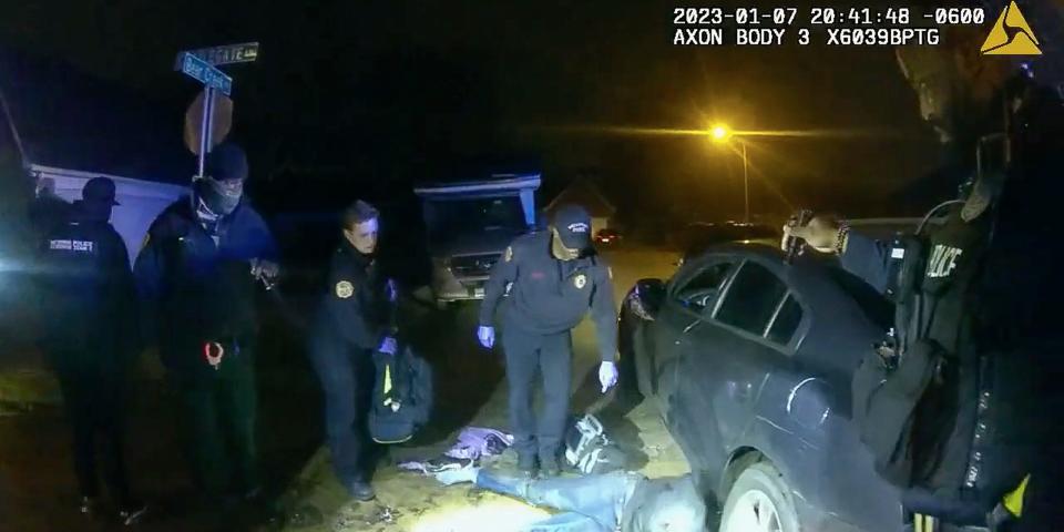 A still from video showing Memphis police officers standing over Tyre Nichols.