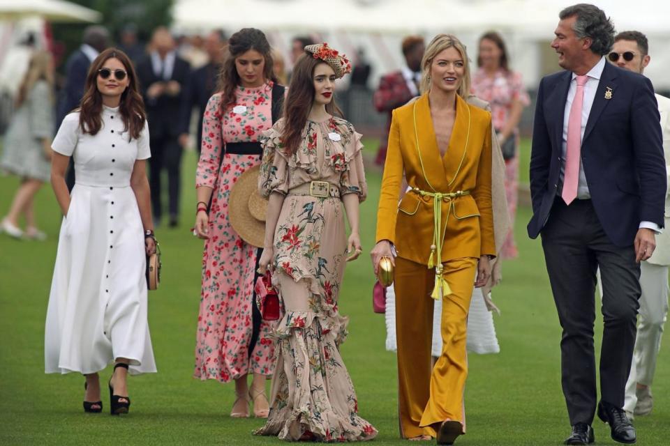 (Left) Jenna Coleman, Lily Collins, centre, Lily Collins, and Martha Hunt, second from right, seen before the start of the polo (PA)