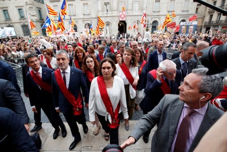 Barcelona's new Mayor Ada Colau walks next to Jaume Collboni, Ernest Maragall and Manuel Valls after her swearing-in ceremony, at Sant Jaume square in Barcelona