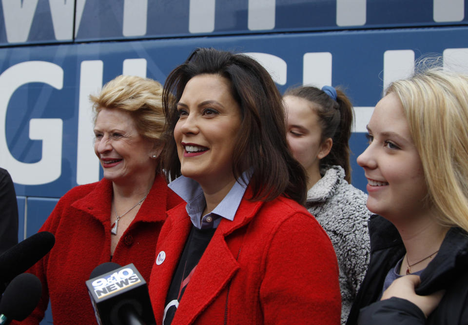 Michigan Democratic gubernatorial candidate Gretchen Whitmer answers questions with Sen. Debbie Stabenow, D-Mich., left, and daughters Sherry, rear, and Sydney, right, after casting her ballot on Nov. 6, 2018, at St. Paul Lutheran Church in East Lansing, Mich. (Photo: Al Goldis/AP)