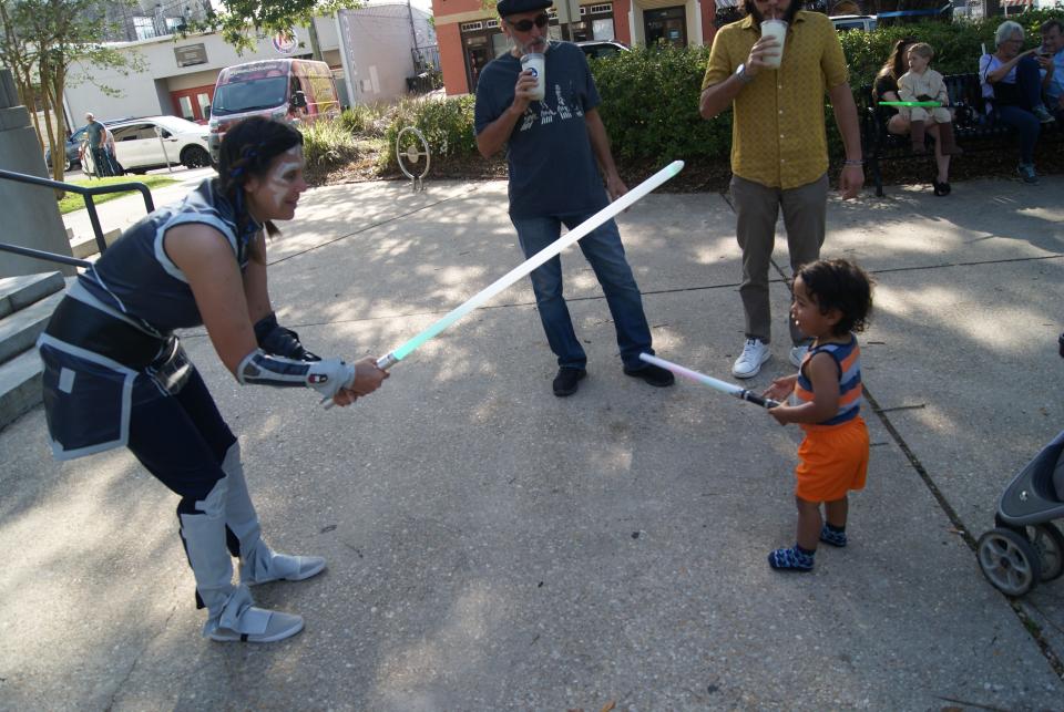 Royal Sullivan, 1-and-a-half, and his grandmother Jennifer Dugas have a lightsaber duel at the Star Wars themed, May the Fourth Be With You, even in the Courthouse Square in Downtown Houma, Thursday, April 4.