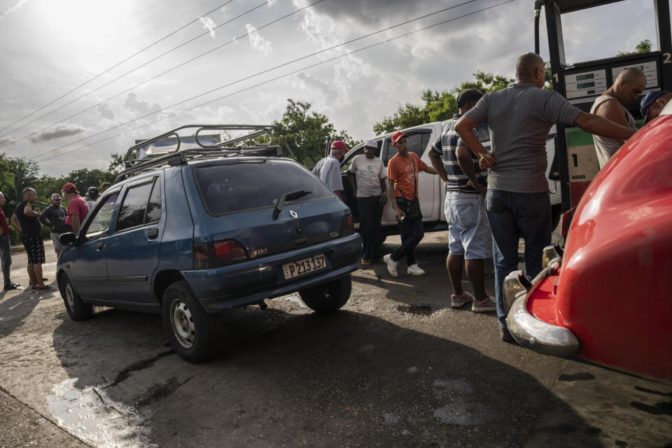 Drivers wait their turn to fuel their vehicles at a gas station in Havana, Cuba, Thursday, July 14, 2022. (AP Photo/Ramon Espinosa)