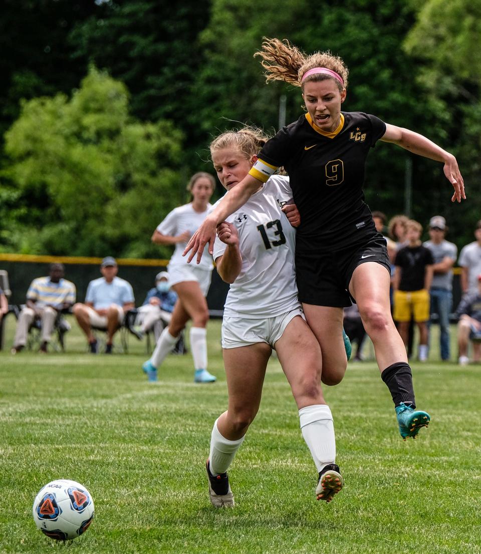 Lansing Christian senior Mia Judd (9) battles with Jackson Lumen Christi sophomore Grace Melville (13) in District Final action Saturday, June 4, 2022. Mia Judd scored a goal and Lansing Christian went on to win 2-0.