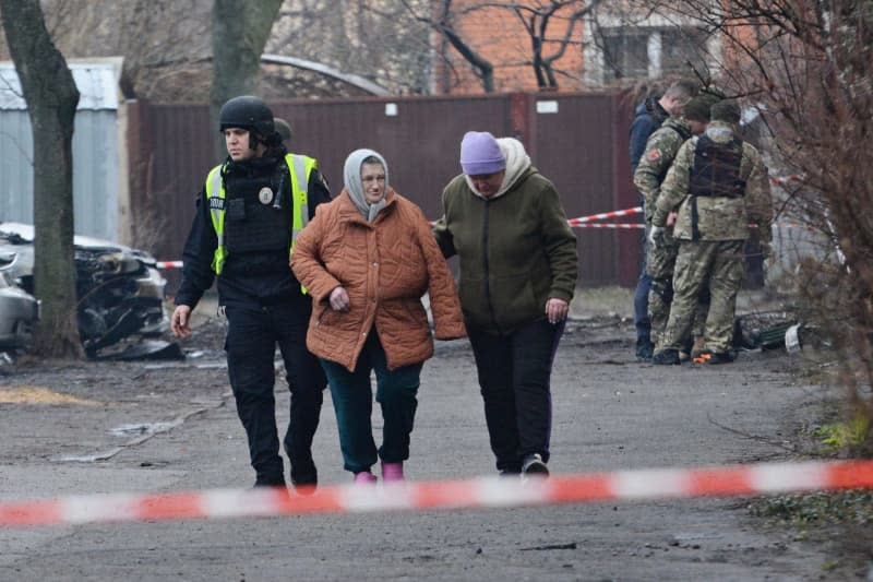 Ukrainian police and rescue workers evacuate residents from a five-story residential building after a rocket attack in Kiev. Aleksandr Gusev/SOPA Images via ZUMA Press Wire/dpa