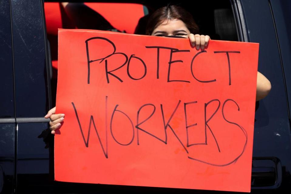 Disney workers stage a car caravan, calling for higher safety standards for Disneyland to reopen.