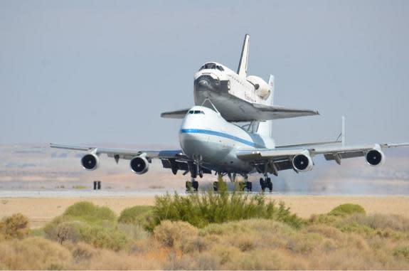 NASA's Space shuttle Endeavour, riding piggyback atop a Shuttle Carrier Aircraft, lands at NASA's Dryden Flight Research Facility in Southern California on Sept. 20, 2012, during the final shuttle ferry flight. Endeavour is headed to Los Angele