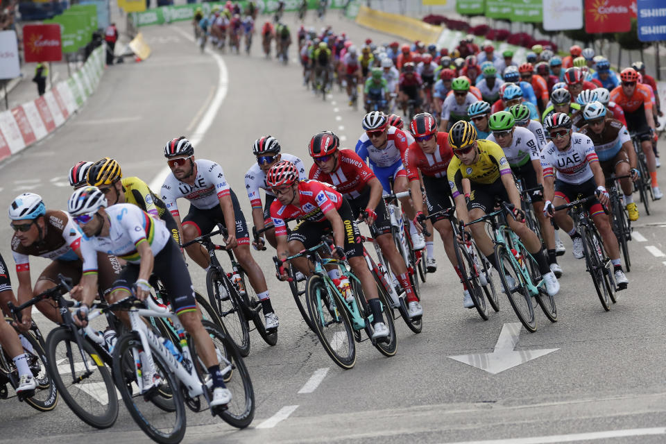 Race leader Primoz Roglic, 6th from left, rides with the pack in the Spanish capital during the La Vuelta cycling race in Madrid, Spain, Sunday, Sept. 15, 2019. (AP Photo/Manu Fernandez)