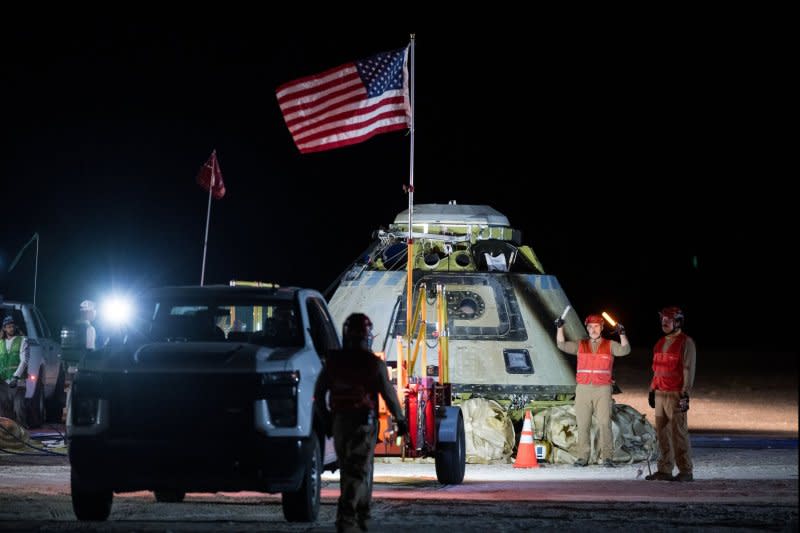 Boeing and NASA teams work around NASA's Boeing Starliner spacecraft after it landed uncrewed on Friday at White Sands, N.M. NASA Photo by Aubrey Gemignani/UPI