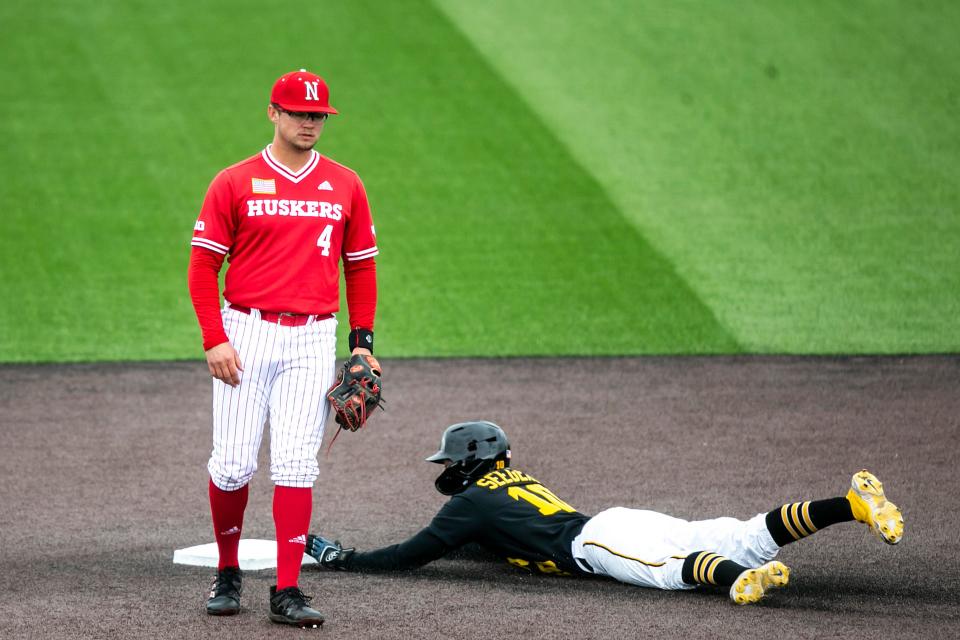 Iowa's Michael Seegers, right, steals second base as Nebraska's Max Anderson looks on during a NCAA Big Ten Conference baseball game, Saturday, April 22, 2023, at Duane Banks Field in Iowa City, Iowa.