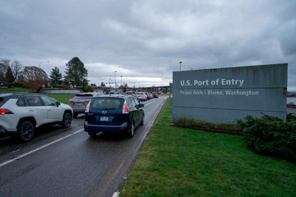 People cross the border between the U.S. and Canada at Peace Arch Park on Friday, March 18, 2022, in Blaine, Wash. Warren Sterling/The Bellingham Herald