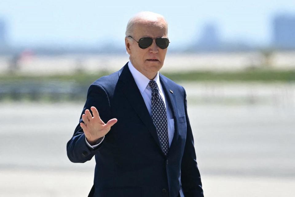 PHOTO: President Joe Biden waves as he walks to board Air Force One as he transits through John F. Kennedy International Airport, April 26, 2024, on his way back to the White House.  (Andrew Caballero-Reynolds/AFP via Getty Images)