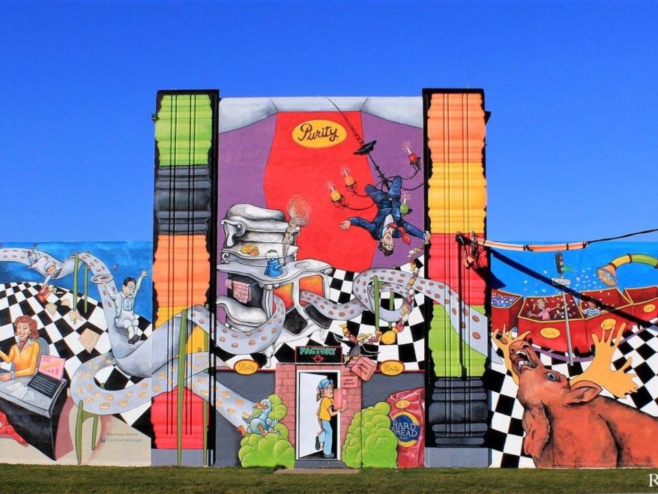 Purity Factories in St. John's — seen here with a mural painted in 2017 — is the setting for an often-told story about Queen Elizabeth's encounter with a factory worker during her visit in 1997. (Submitted by Randy Whitten - image credit)