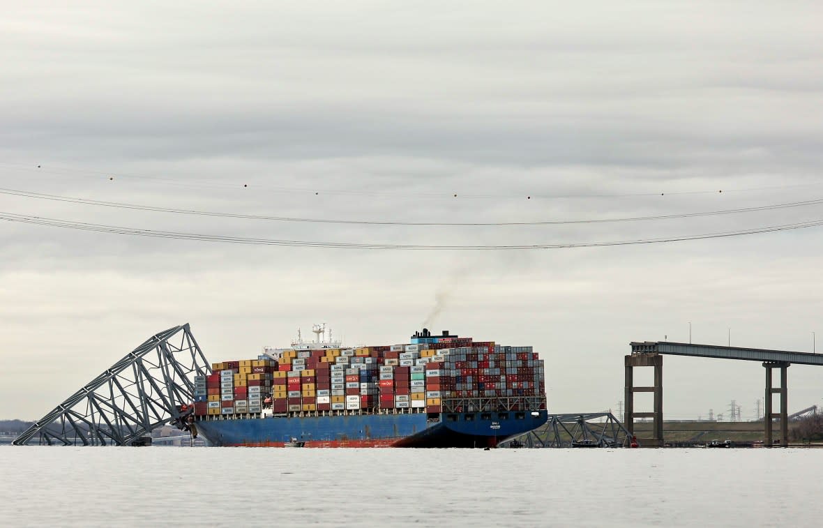 BALTIMORE, MARYLAND - MARCH 26: The cargo ship Dali sits in the water after running into and collapsing the Francis Scott Key Bridge on March 26, 2024 in Baltimore, Maryland. According to reports, rescuers are still searching for multiple people, while two survivors have been pulled from the Patapsco River. A work crew was fixing potholes on the bridge, which is used by roughly 30,000 people each day, when the ship struck at around 1:30am on Tuesday morning. The accident has temporarily closed the Port of Baltimore, one of the largest and busiest on the East Coast of the U.S. (Photo by Kevin Dietsch/Getty Images)