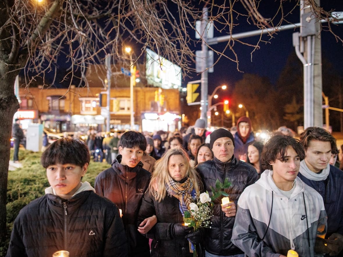 Andrea Magalhaes leads a procession to Keele subway station in Toronto on March 30, 2023. Her son, Gabriel Magalhaes, 16, was fatally stabbed at the station on the weekend. (Evan Mitsui/CBC - image credit)