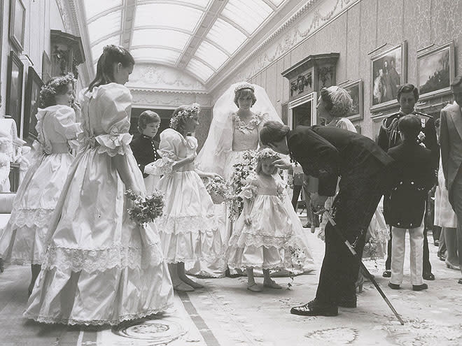 <p>Prince Andrew (bending) and Princes Charles (right) chat with the wedding attendants after the elaborate ceremony at St. Paul's Cathedral in London.</p>