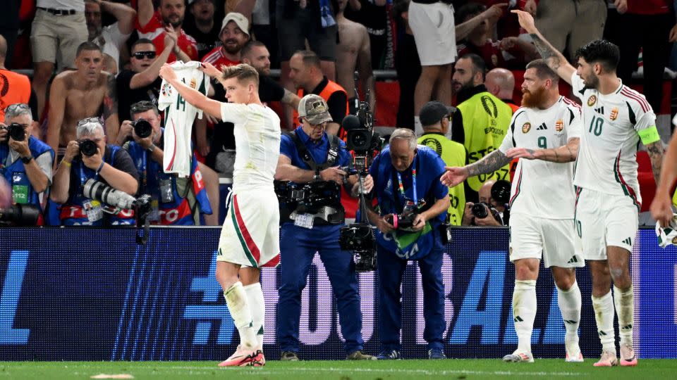 Kevin Csoboth holds up the shirt with Varga's name on it after scoring for Hungary against Scotland. - Marijan Murat/dpa/picture alliance/Getty Images