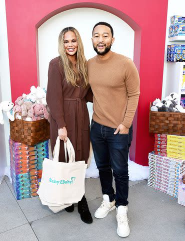 Michael Kovac/Getty Chrissy Teigen and John Legend at Baby2Baby holiday event in 2021