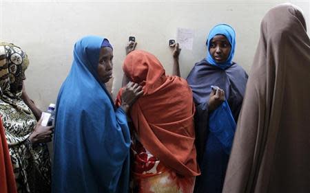 Leyla Ali Adow (C), a suspected Somali illegal migrant arrested in a police swoop reacts after being processed for deportation at a holding station in Kenya's capital Nairobi, April 9, 2014. REUTERS/Thomas Mukoya