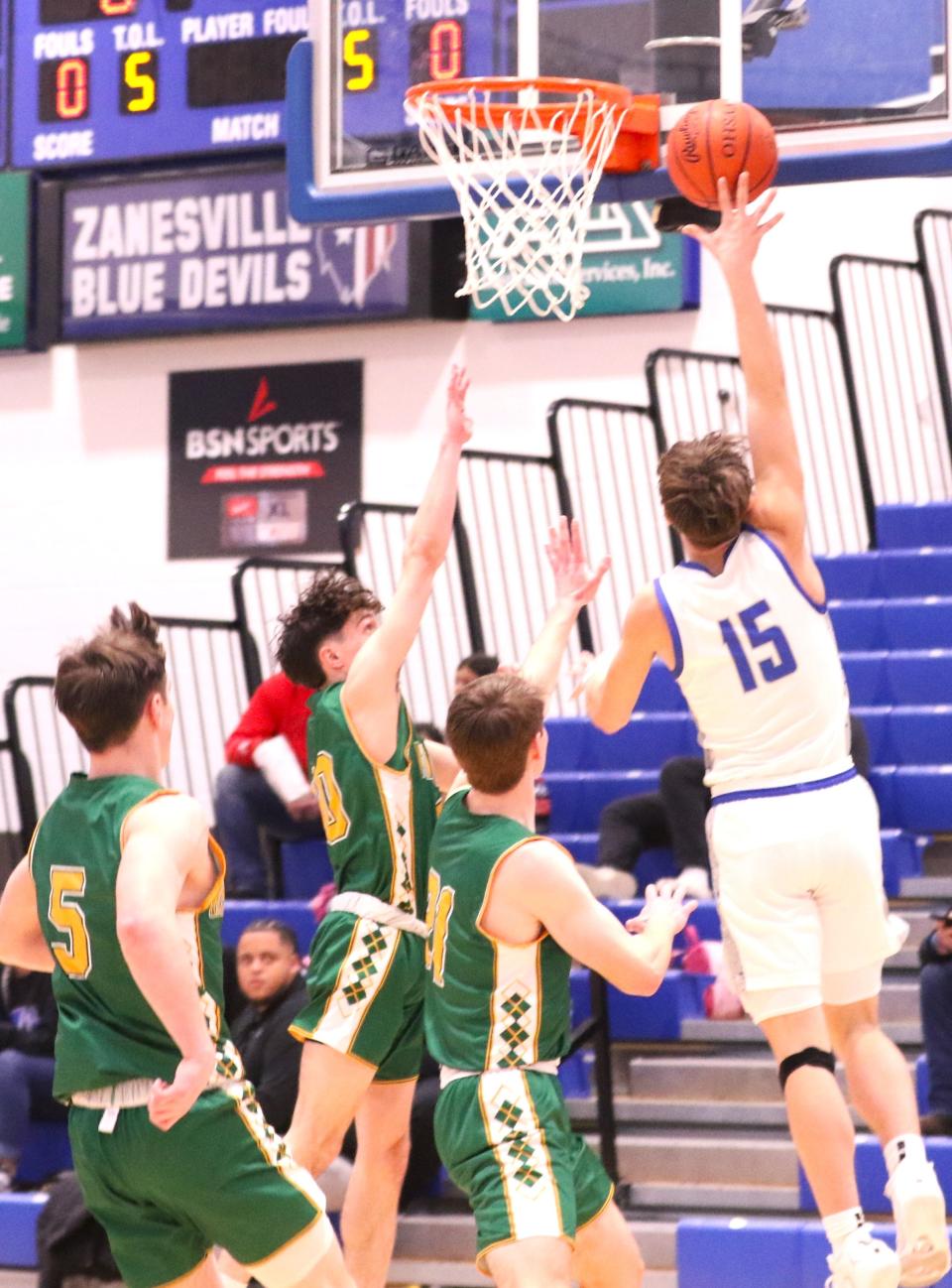 Zanesville's Maddox Hayes lays the ball in against Newark Catholic on Tuesday. The Blue Devils won 58-47.