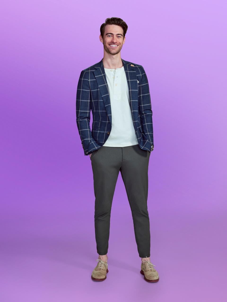 Nolan, a candidate on "Love is blind" Season 6, wears a checkered blue jacket and grey pants