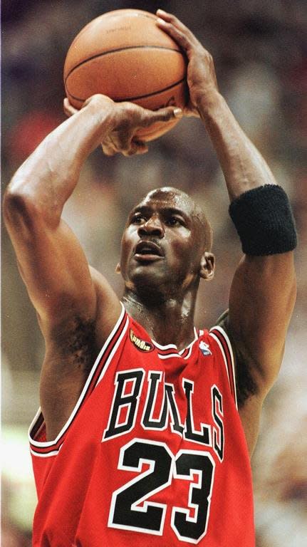 Michael Jordan, shown playing for the Chicago Bulls in 1998. Jordan turned high-leaping slam dunks, clutch game-winning baskets and defensive determination into performance art for the Chicago Bulls, leading them to NBA titles from 1991-1993 and 1996-1998 with a retirement in between