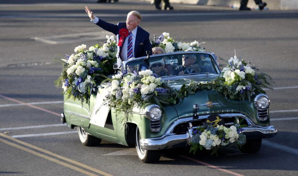 Dodgers broadcaster and Rose Parade grand marshal Vin Scully waves to the fans during the 125th Rose Parade on Jan. 1, 2014.