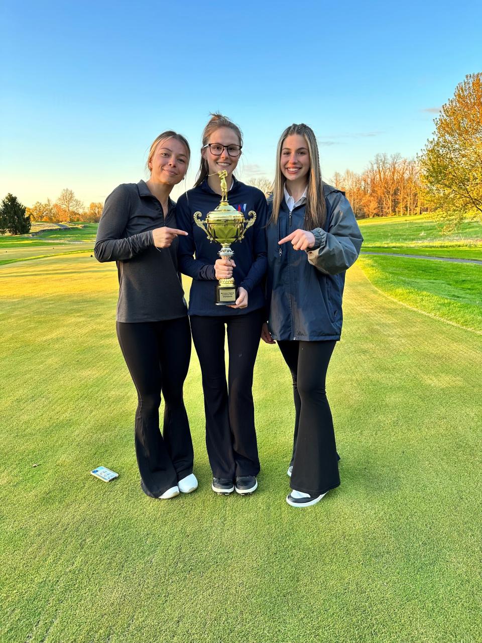 Wappingers girls golf teammates pose with the trophy after winning the Mid-Hudson Regional Tournament at Trump National Hudson Valley in Hopewell Junction on April 25, 2023. From left: Kayla Kinkel, Kate Robisch and Madison Townsend.
