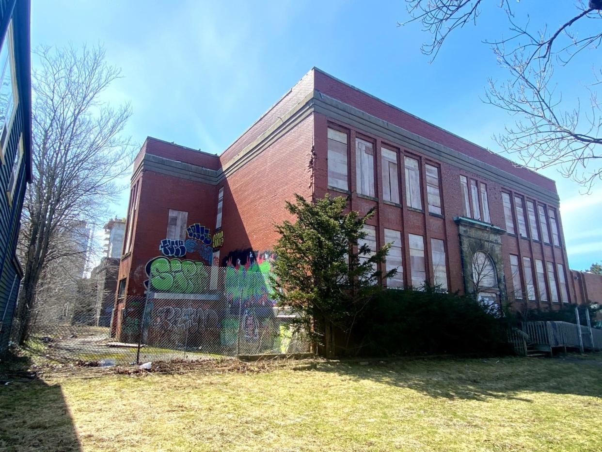 One of the two oldest buildings on the Bloomfield site in Halifax faces Agricola Street. A structural assessment says this building has a partial roof collapse and issues with load-bearing brick walls.  (Haley Ryan/CBC - image credit)