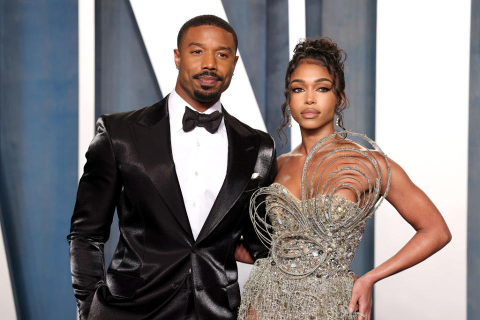 Michael B. Jordan in a tuxedo and Lori Harvey in an embellished gown pose together at a formal event
