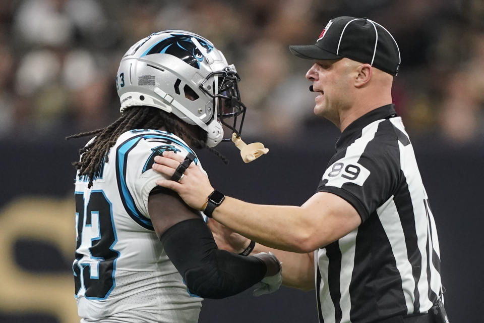 Umpire Mike Morgan pushes Carolina Panthers running back D'Onta Foreman back during the second half an NFL football game between the Carolina Panthers and the New Orleans Saints in New Orleans, Sunday, Jan. 8, 2023. (AP Photo/Gerald Herbert)