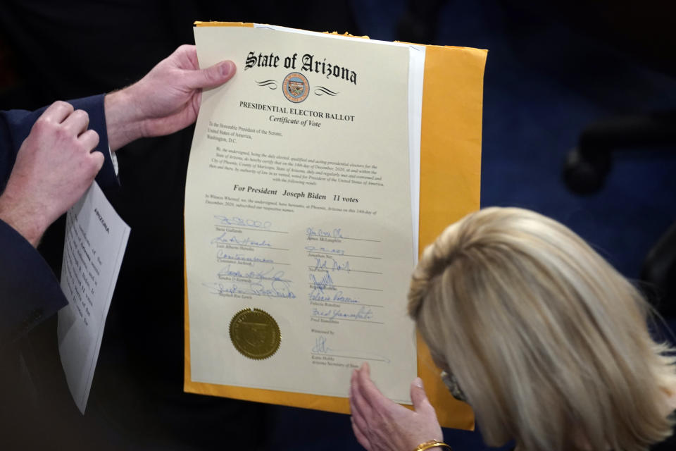The certification of Electoral College votes for the state of Arizona is unsealed during a joint session of the House and Senate on Jan. 6, 2021. 
