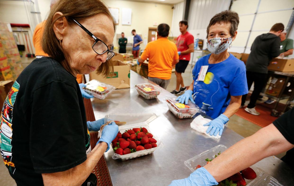 Volunteers sort produce to be donated to needy local families at Ozarks Food Harvest on June 21, 2021. The nonprofit serves 28 Missouri counties and hopes to bring in $30,000 in monetary donations for Giving Tuesday on Nov. 30, 2021.