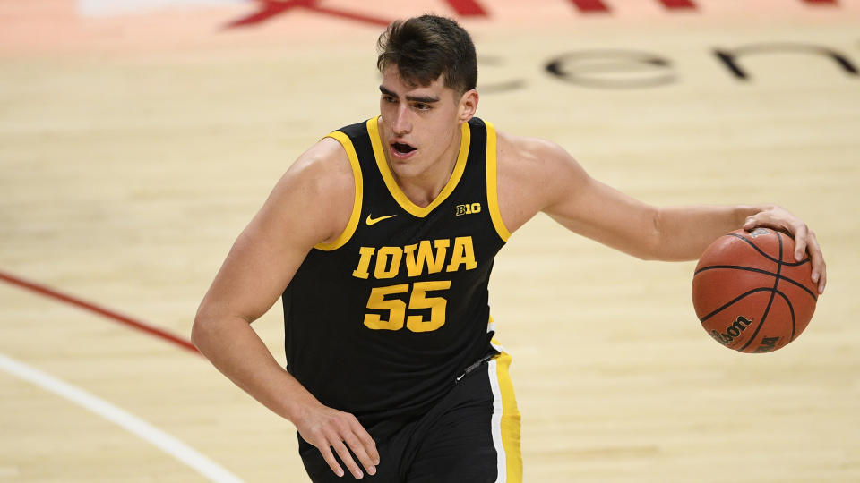 Iowa center Luka Garza (55) dribbles the ball during the first half of an NCAA college basketball game against Maryland, Thursday, Jan. 7, 2021, in College Park, Md. (AP Photo/Nick Wass)