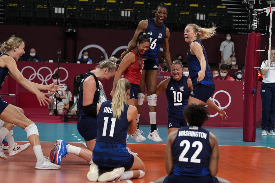 United States players celebrate winning the women's volleyball semifinal match between Serbia and United States at the 2020 Summer Olympics, Friday, Aug. 6, 2021, in Tokyo, Japan. (AP Photo/Frank Augstein)