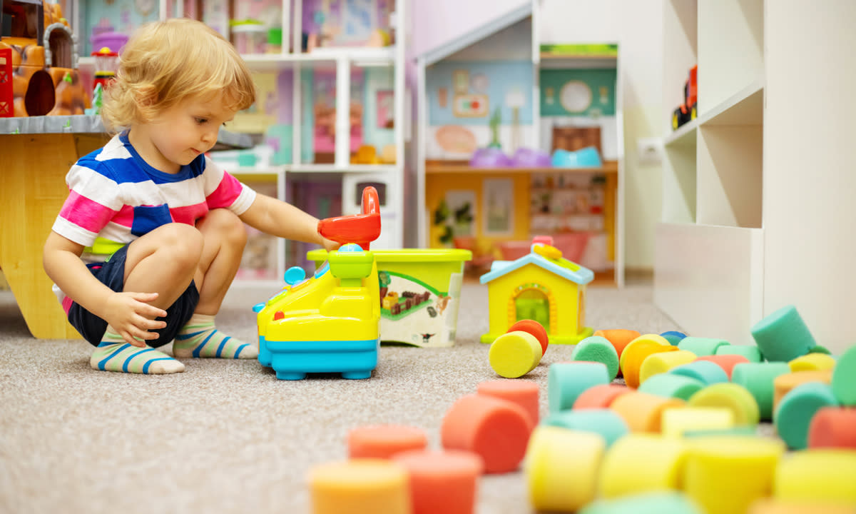 A photo of a young child playing at a day care