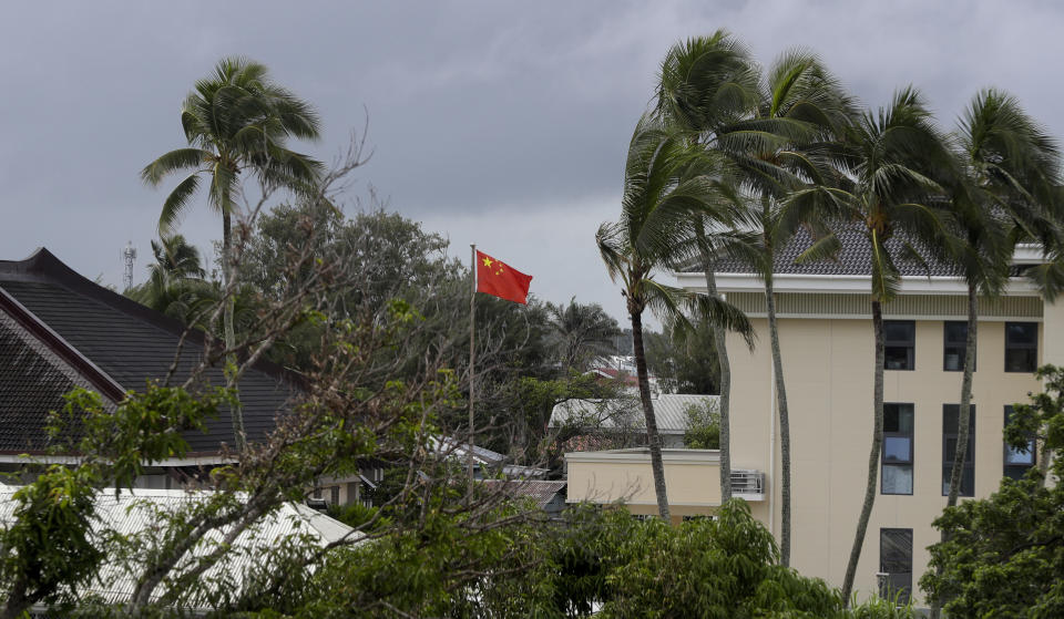 In this April 8, 2019, photo, a Chinese flag flies outside the Chinese Embassy in Nuku'alofa, Tonga. China is pouring billions of dollars in aid and low-interest loans into the South Pacific, and even in the far-flung kingdom of Tonga there are signs that a battle for power and influence among much larger nations is heating up and could exact a toll. (AP Photo/Mark Baker)