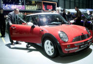 FILE PHOTO: A visitor looks at the new Mini Cooper on display as a first world presentation at the Geneva car show February 27, 2001. REUTERS/Stringer/File Photo