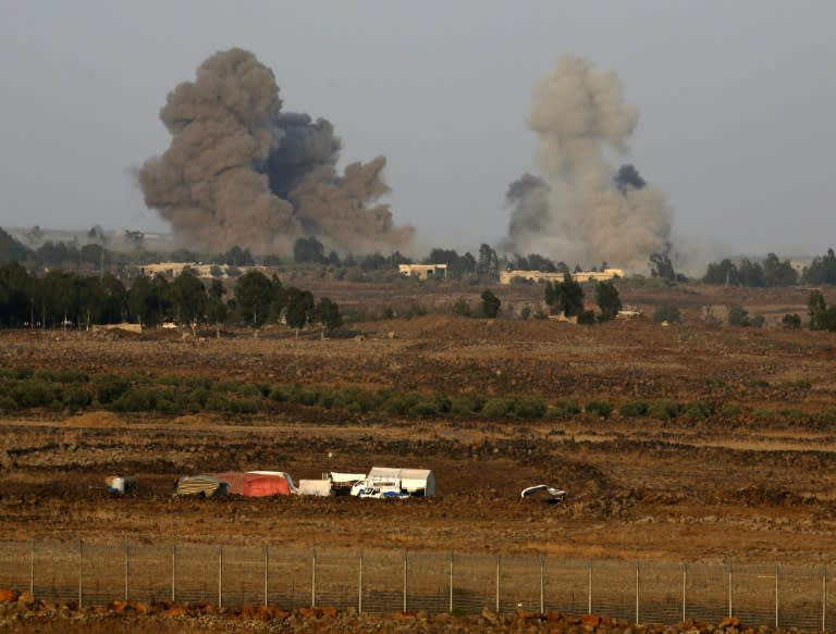 A picture taken on July 24, 2018 from the Tal Saki hill in the Israeli-annexed Golan Heights shows smoke rising across the border in Syria during air strikes as regime forces pressed an offensive against Daraa province