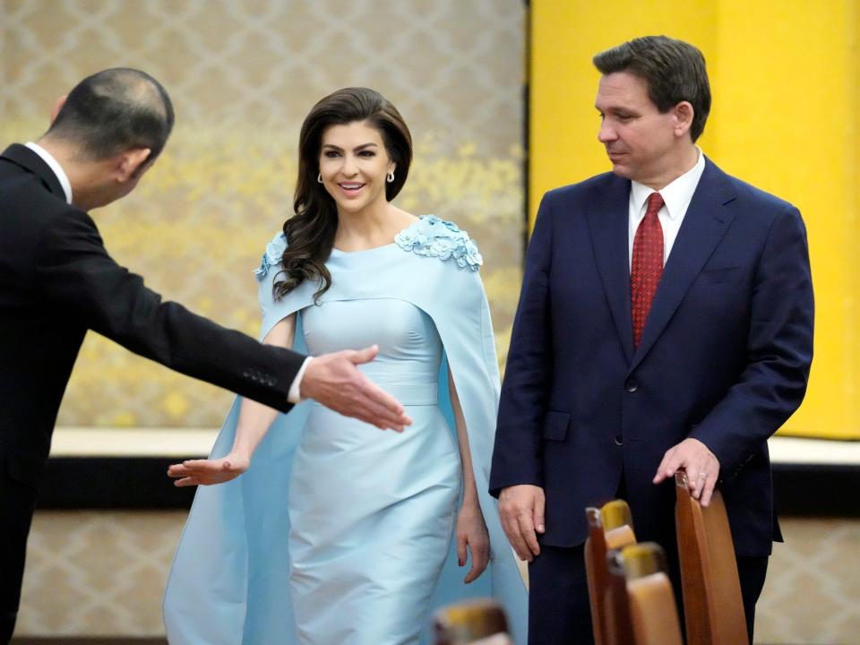 Florida Gov. Ron DeSantis, right, and his wife Casey are escorted to their seats for a meeting with Japanese Foreign Minister Yoshimasa Hayashi, not in picture, at Iikura Guest House Monday, April 24, 2023, in Tokyo.