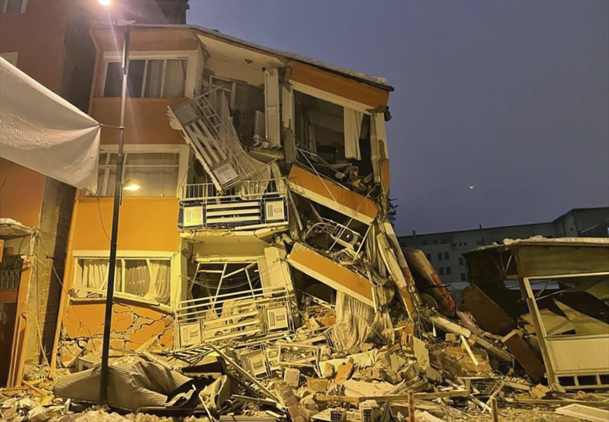 A collapsed building is seen following an earthquake in Pazarcik, in Kahramanmaras province, southern Turkey, early Monday, Feb. 6, 2023. A powerful earthquake has caused significant damage in southeast Turkey and Syria and many casualties are feared. Damage was reported across several Turkish provinces, and rescue teams were being sent from around the country.(Depo Photos via AP)
